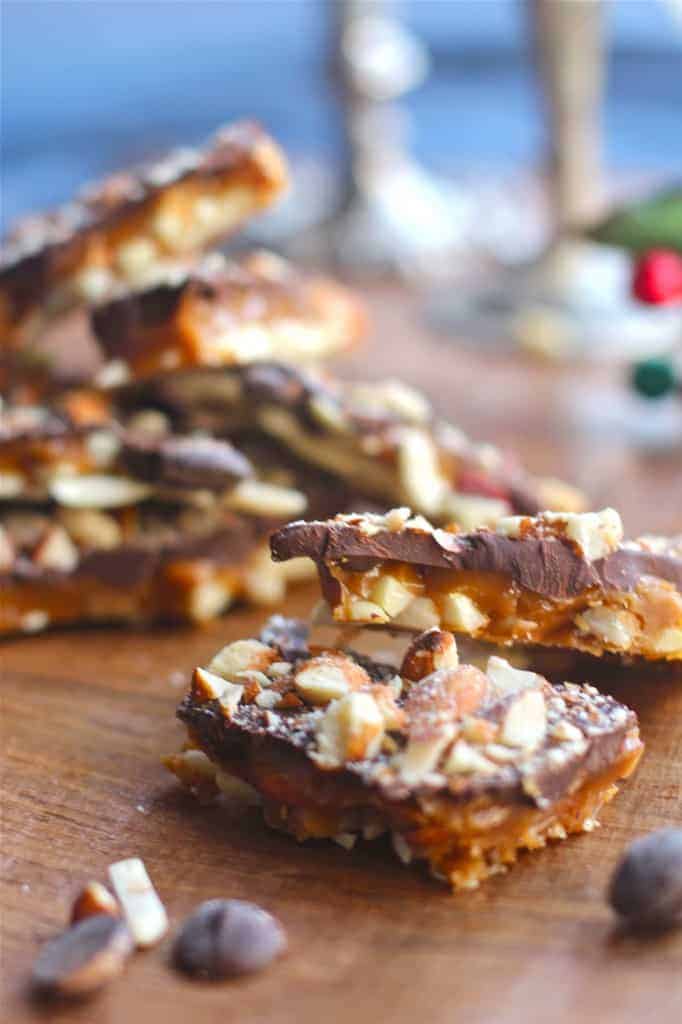 English butter toffee stacked on a wood surface. 