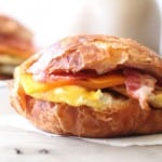 closeup of croissant breakfast sandwiches on a white napkin