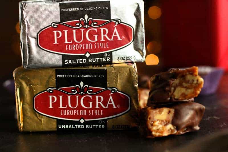 plugra butter stacked in gold and silver wrappers with the candy next to it. 