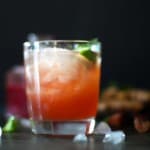 rhubarb cocktail with mint and lime on black background.