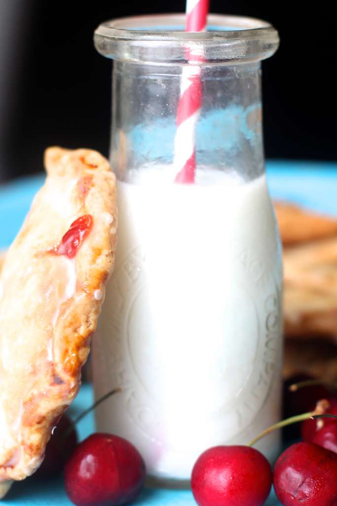 closeup of glass milk jar with hand pies leaning on it