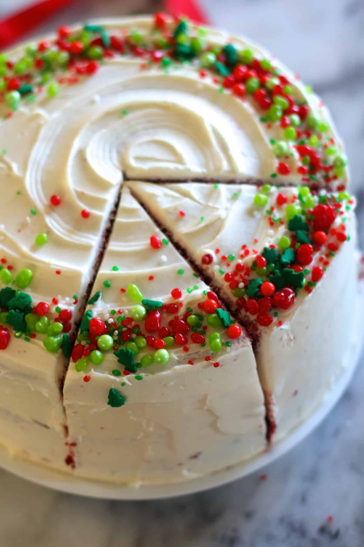 sliced red velvet cake with red and green sprinkles. 