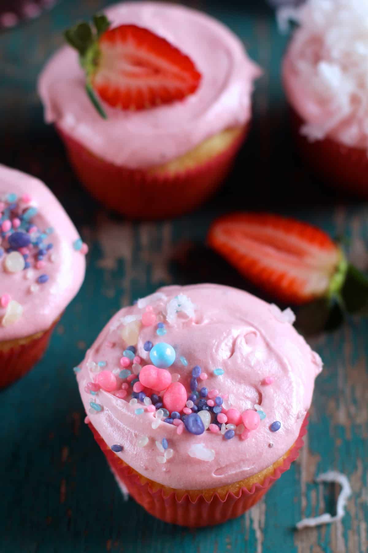 A light and buttery coconut cupcake topped with fresh strawberry frosting