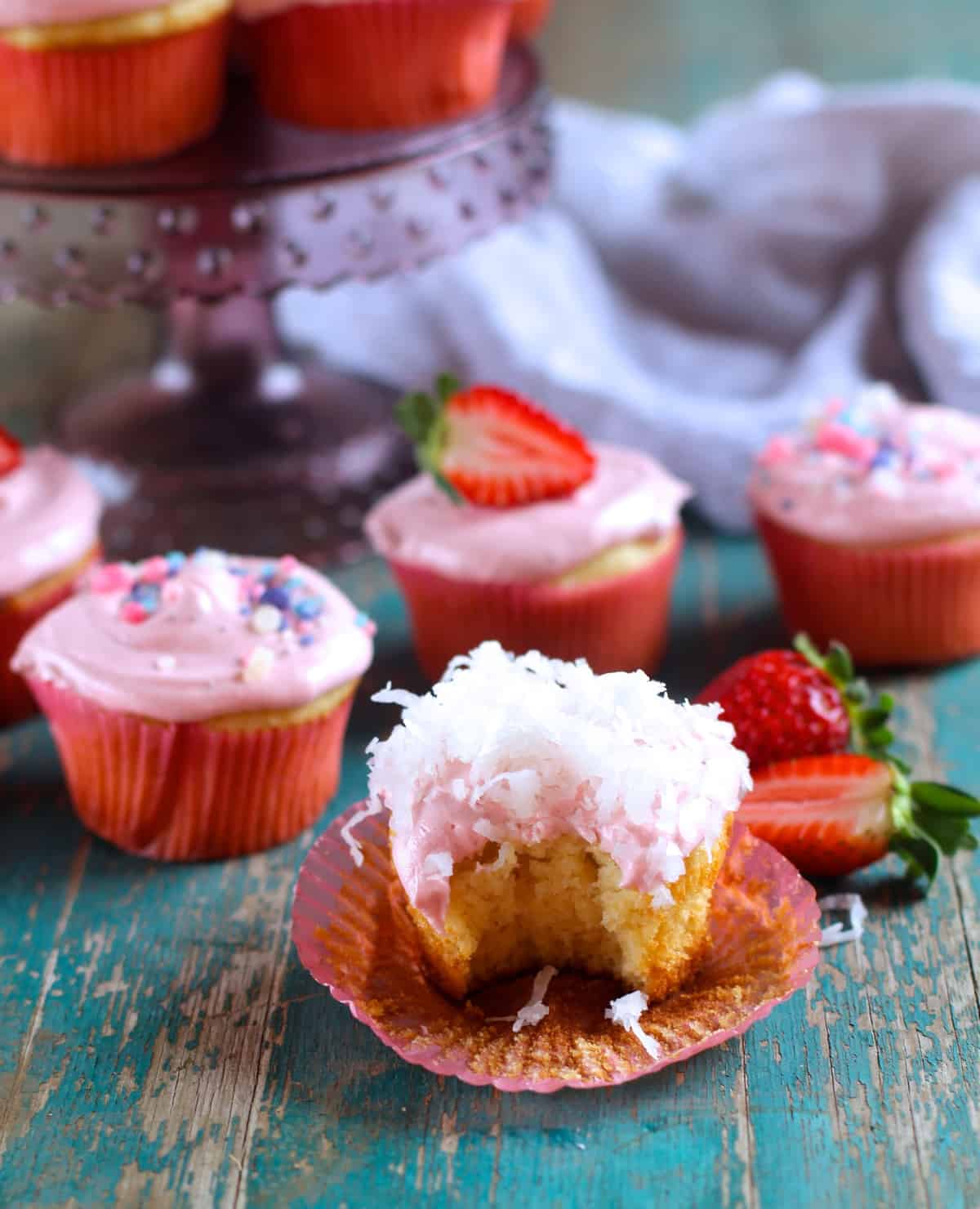 A light and buttery coconut cupcake topped with fresh strawberry frosting