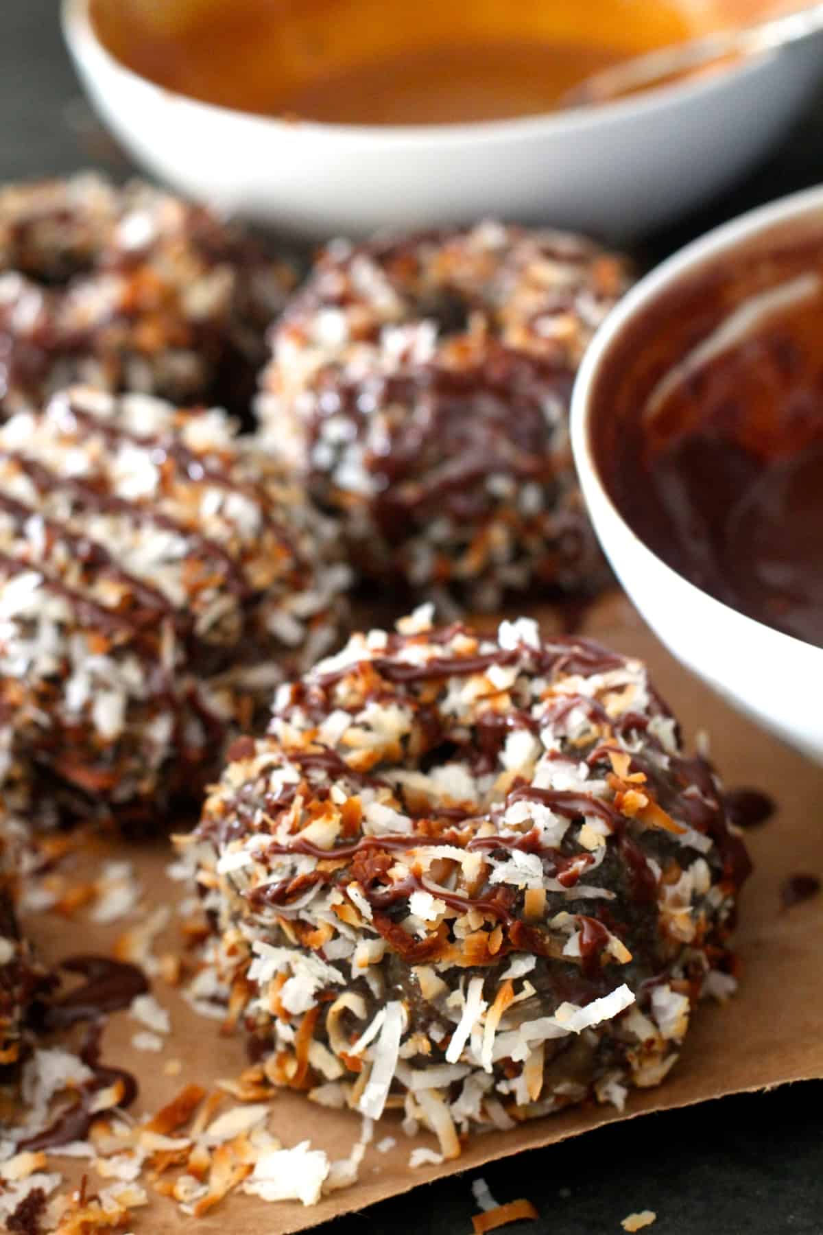 closeup of samoa cake covered in chocolate, caramel, and coconut flakes
