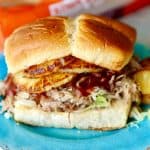 Easy Slow Cooker pork that is tender and shreds with a fork. Served on Hawaiian Sweet Bread with Teriyaki sauce and pineapple and perfect for serving a crowd!