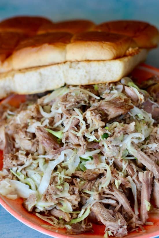 Easy Slow Cooker pork that is tender and shreds with a fork. Served on Hawaiian Sweet Bread with Teriyaki sauce and pineapple and perfect for serving a crowd!
