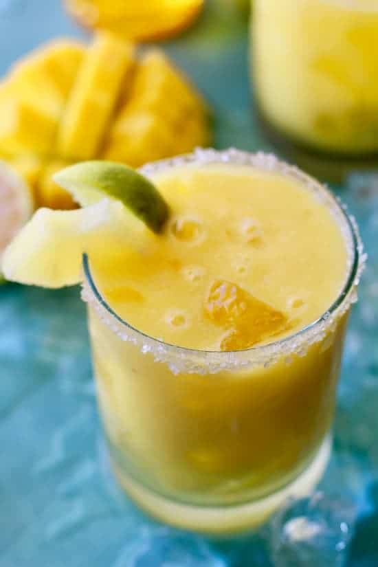 Easy to make margarita made with fresh mango, pineapple juice and passion fruit syrup. The perfect drink on a hot summer day! 