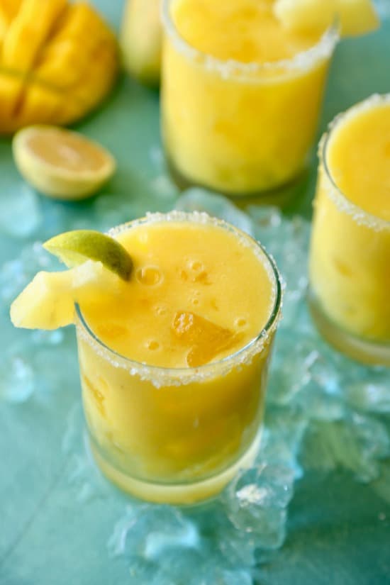 Easy to make margarita made with fresh mango, pineapple juice and passion fruit syrup. The perfect drink on a hot summer day! 