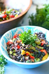 A delicious salad made of lentils, quinoa, and rice combined with fresh crunchy veggies and a delicious mustard dressing.