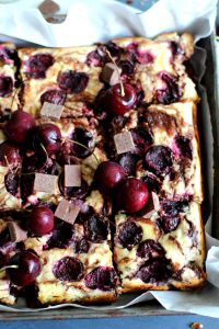 Decadent dark chocolate brownies, swirled with silky cream cheese cheesecake filling, and studded with sweet summer cherries.