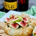 Fresh tiger fig topped baked brie in crispy puff pastry