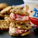 Soft and chewy white chocolate chip cookies studded with dried cherries that sandwich cherry cheesecake ice cream