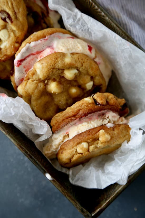 Soft and chewy white chocolate chip cookies studded with dried cherries that sandwich cherry cheesecake ice cream