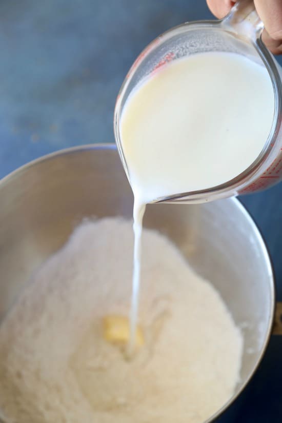 pouring milk into flour bowl