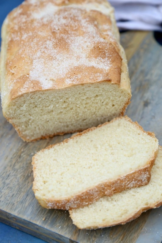 Easy English Muffin Bread loaf with 2 slices on cutting board