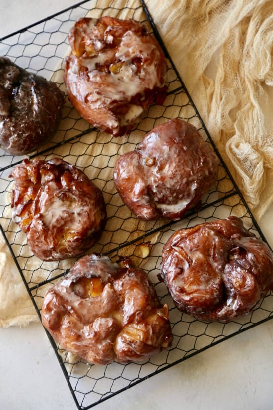 Six hot and fresh, just like Donut Shop Apple Fritter donuts on cooling rack