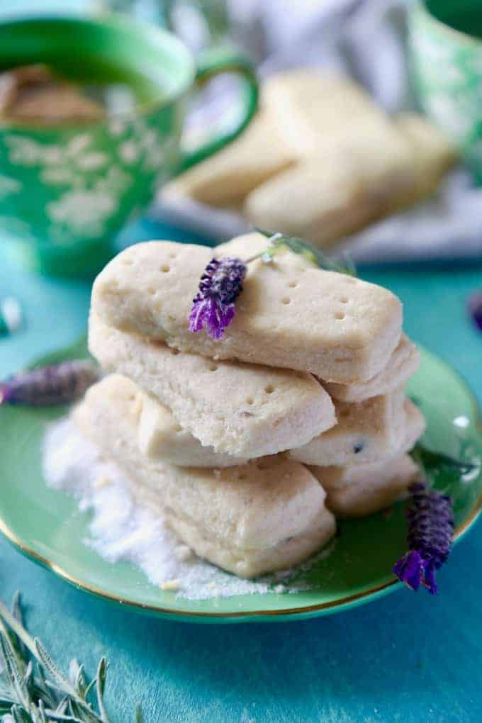 up close green plate with lavender cookies stacked