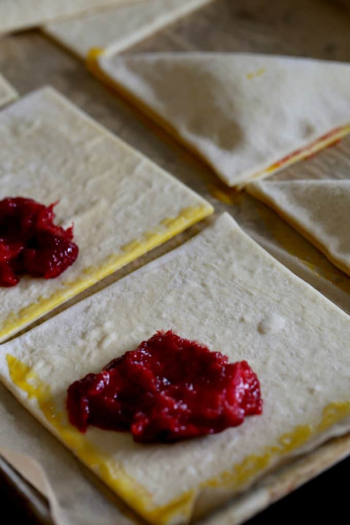 Puff pastry with a spoonful of fruit compote in the corner before folding into a triangle. 