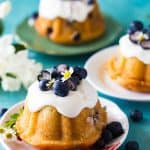 three mini blueberry bundt cakes on individual serving plates