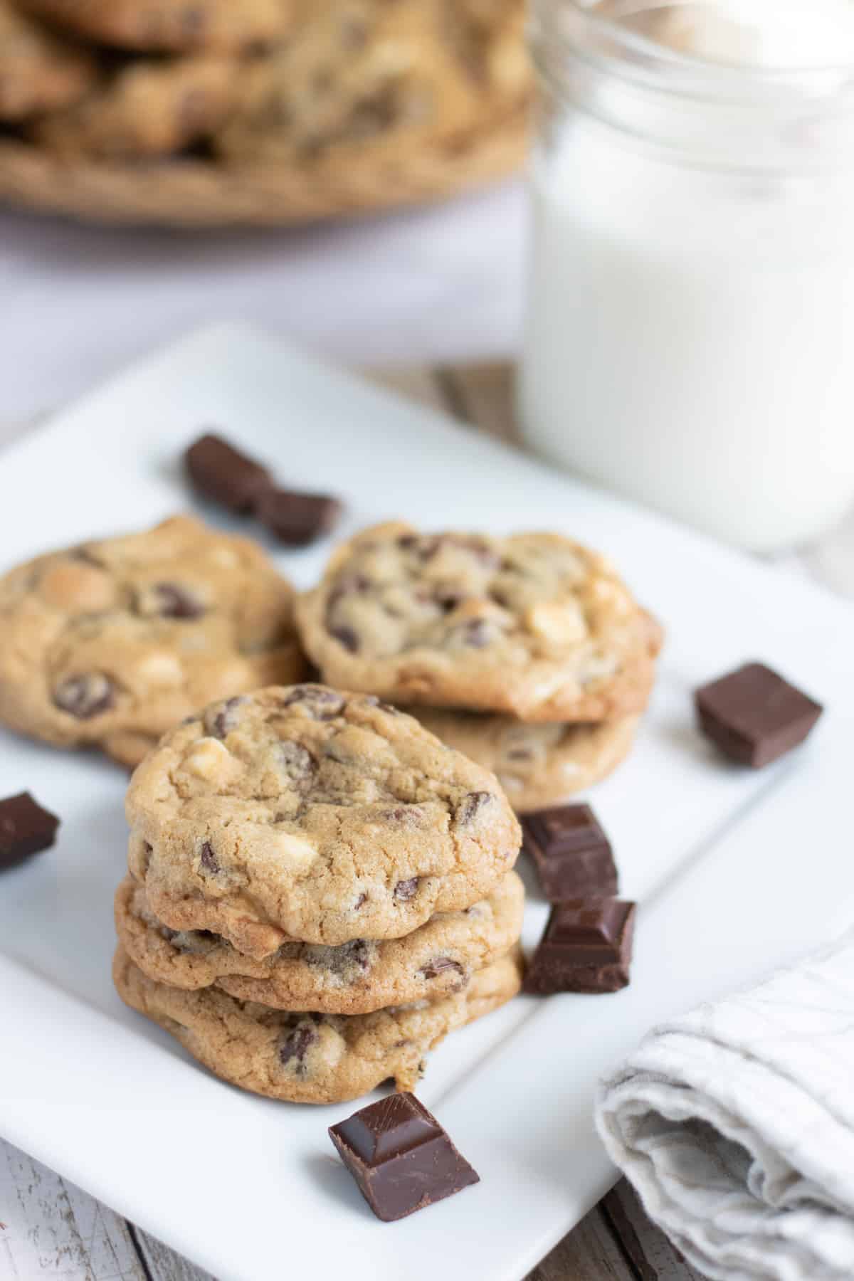 Triple Chocolate cookies on a plate with chocolate chunks scattered about