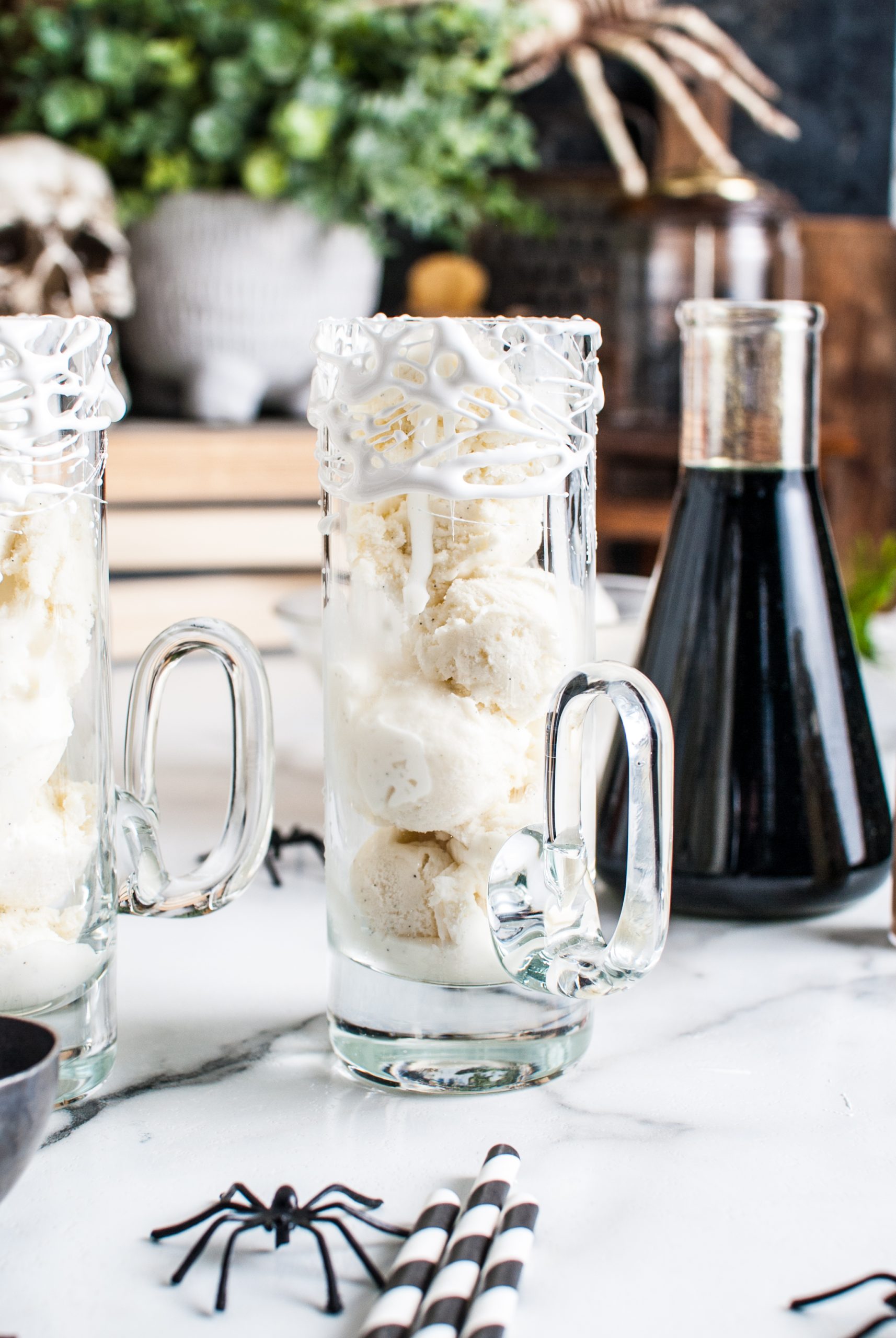 Ice cream scoops stacked into the tall glass rimmed with marshmallow. 