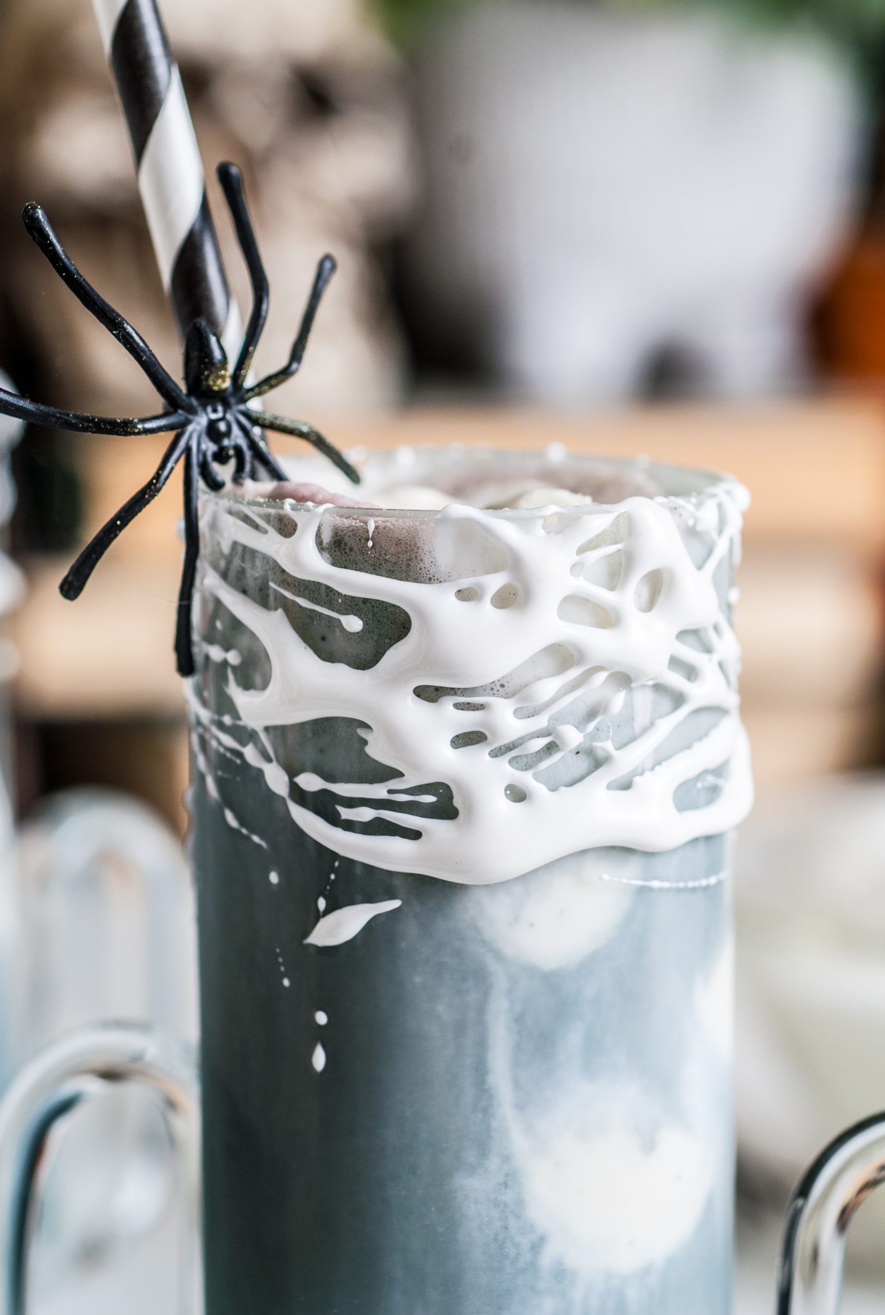 Up close shot of the marshmallow weeping on the top of the glass. 