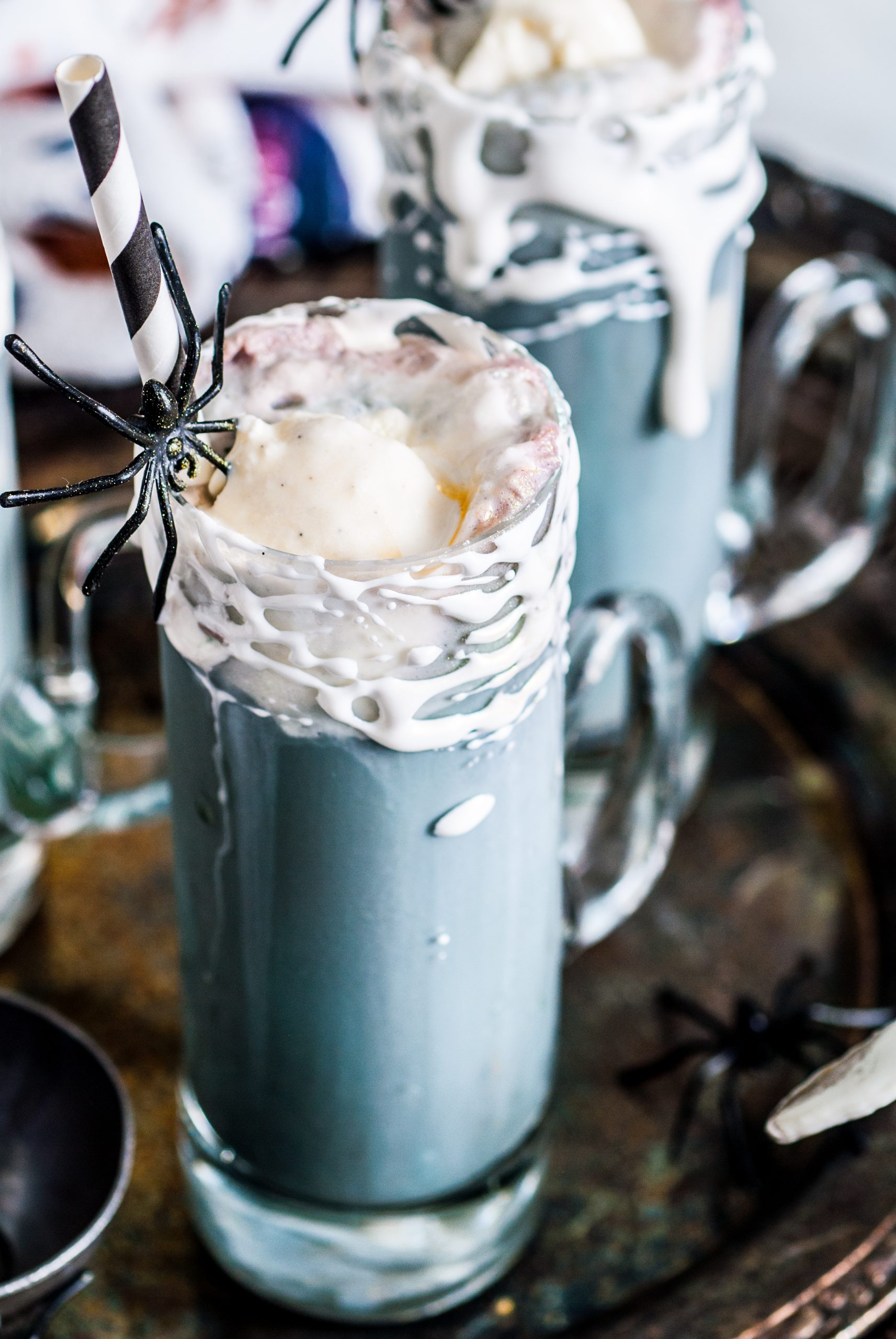 Up close shot of the glass with marshmallow webs and black root beer float. 