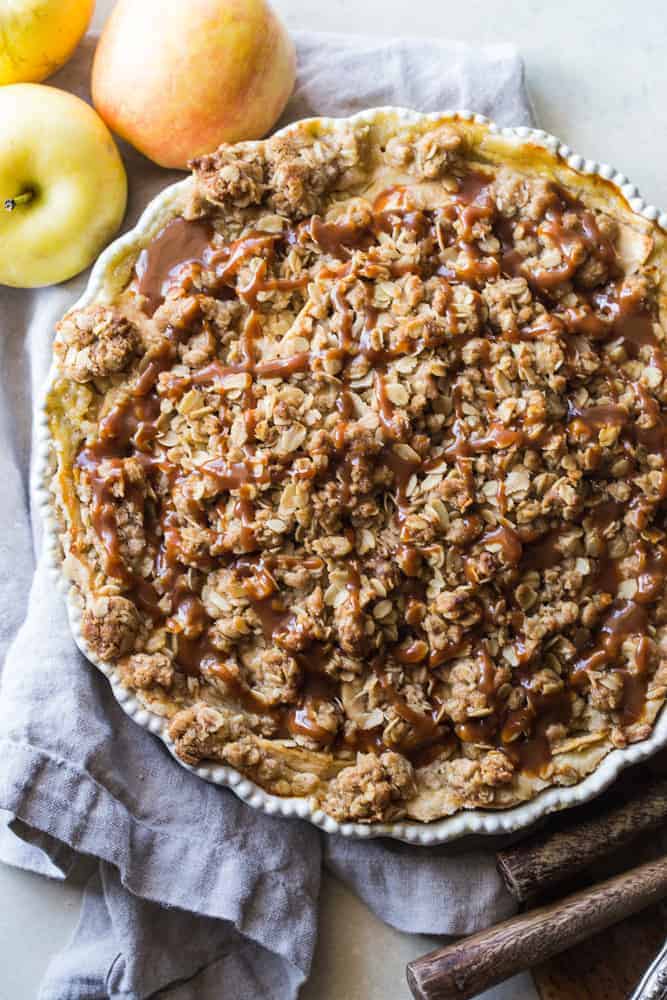 Apple buttermilk pie with oatmeal streusel topping on a beige dish towel