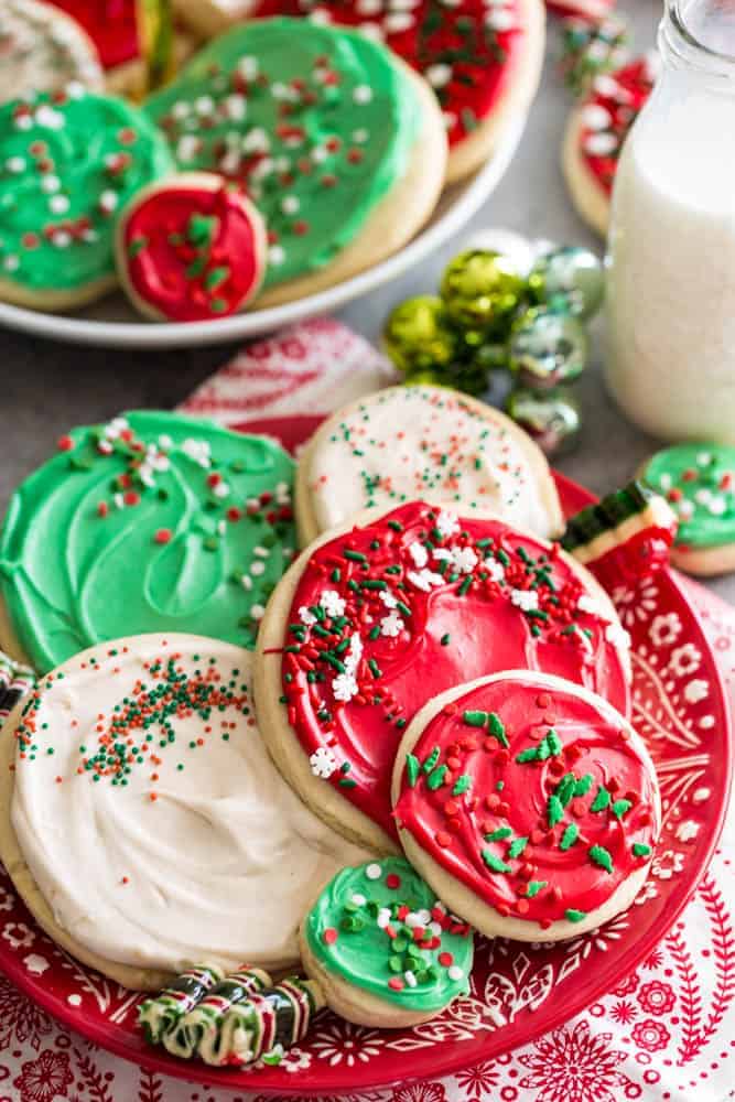 Copycat Swig Sugar Cookies on a red Christmas plate with ornaments around the plate. 