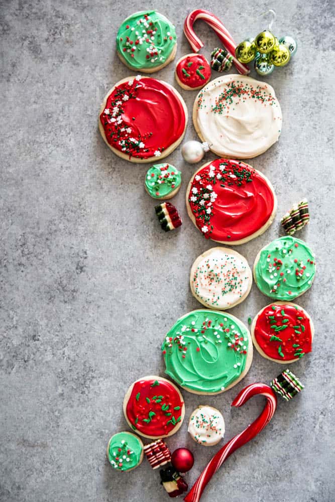 Copycat Swig Sugar Cookies on a metal background with candy canes and green ornaments around them. 