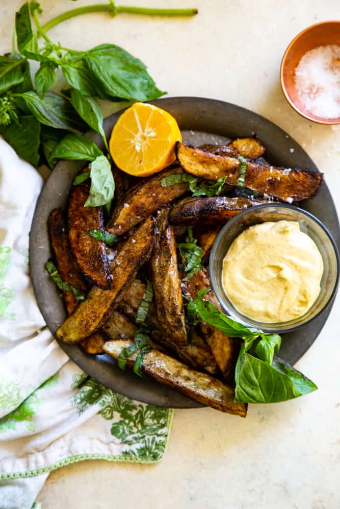 Overhead shot of the plated wedges with a small bowl of the garlic aioli. 