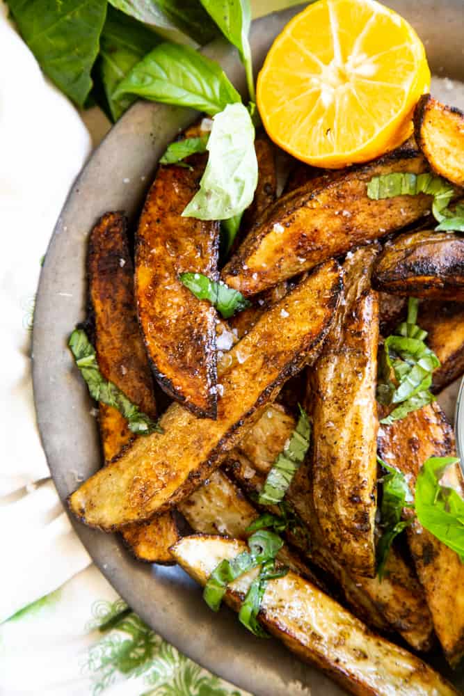 Close up shot to the Crispy wedges with flaked sea salt on a metal plate. 