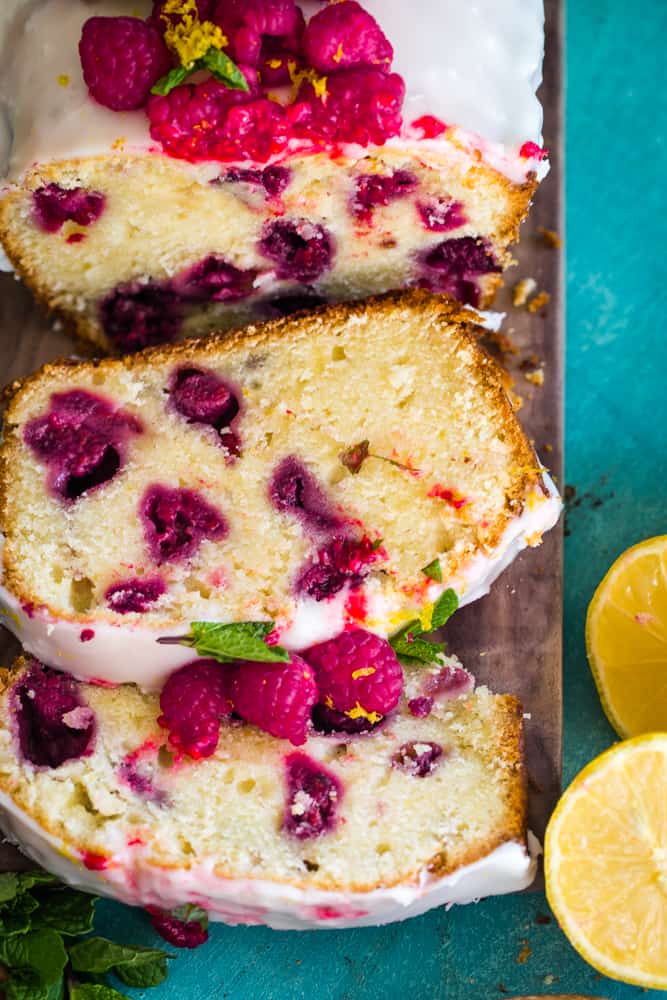 Overhead shot of the pound cake cut with two slices showing the raspberries baked in. 