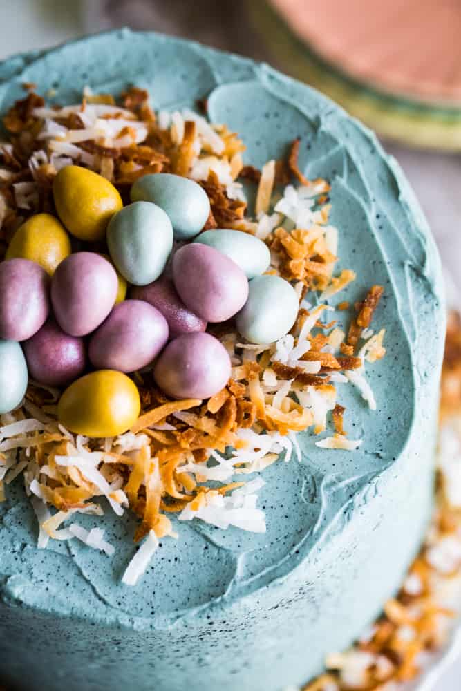 Overhead shot of the cake with the toasted coconut nest and chocolate eggs. 
