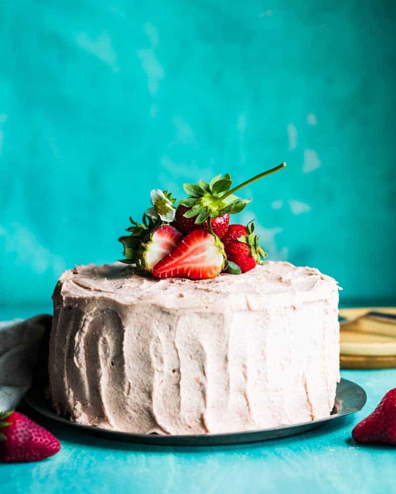 strawberry rhubarb layer cake with strawberries on top