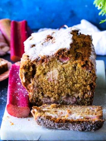 rhubarb streusel bread on white board with blue background.