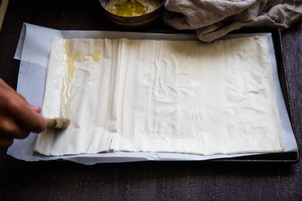 buttering the phyllo dough for the apple strudel