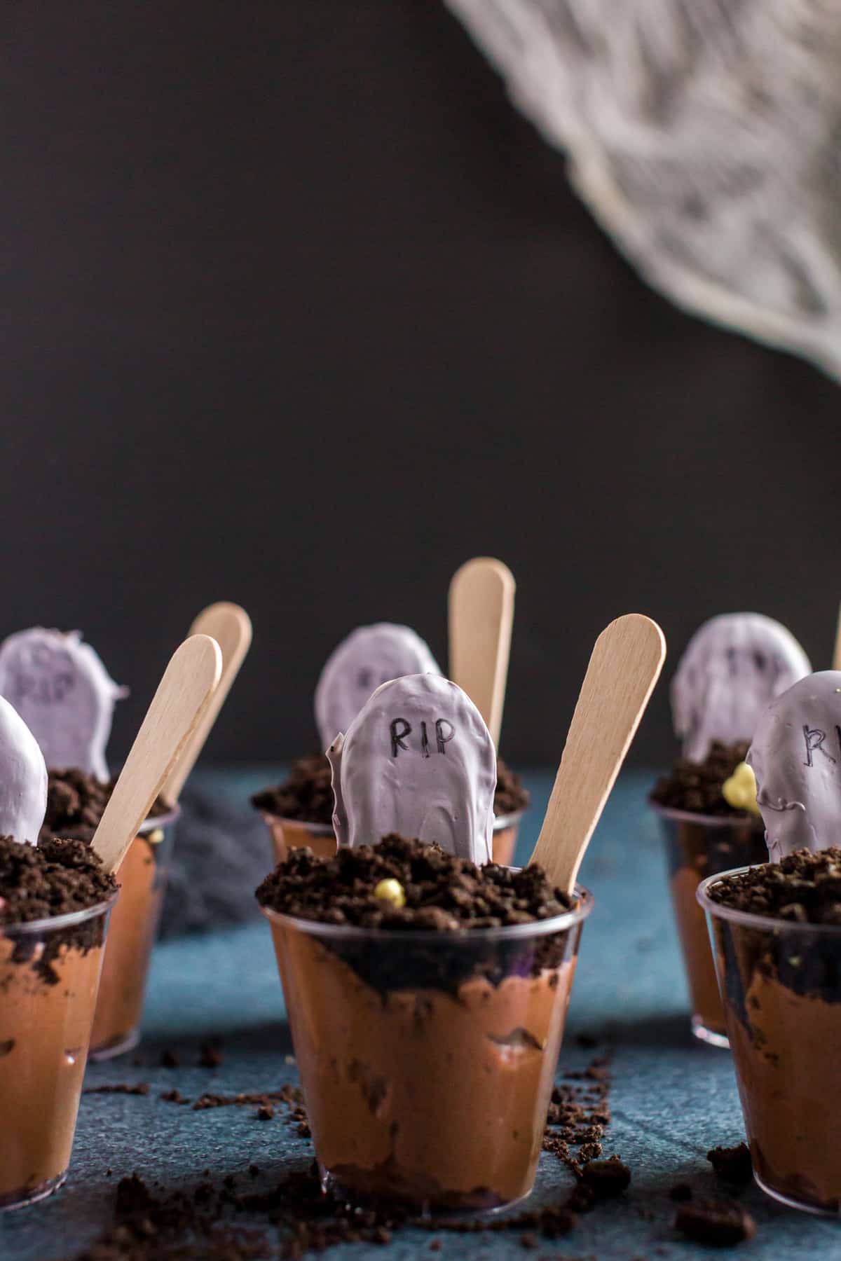 Up close shot of the assembled pudding cups with black dark background. 