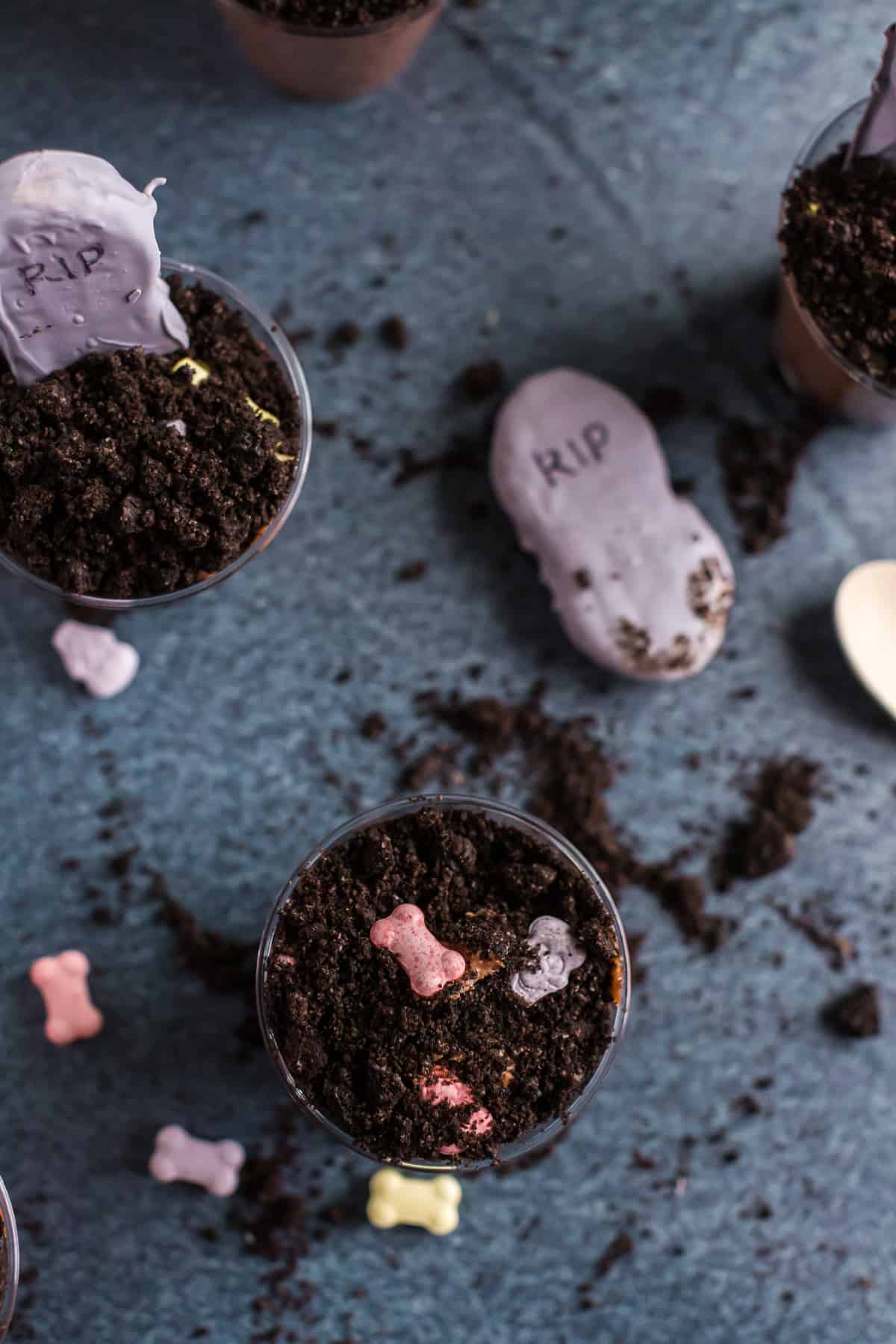 graveyard pudding cups from top angle view with candy skull and bones. 