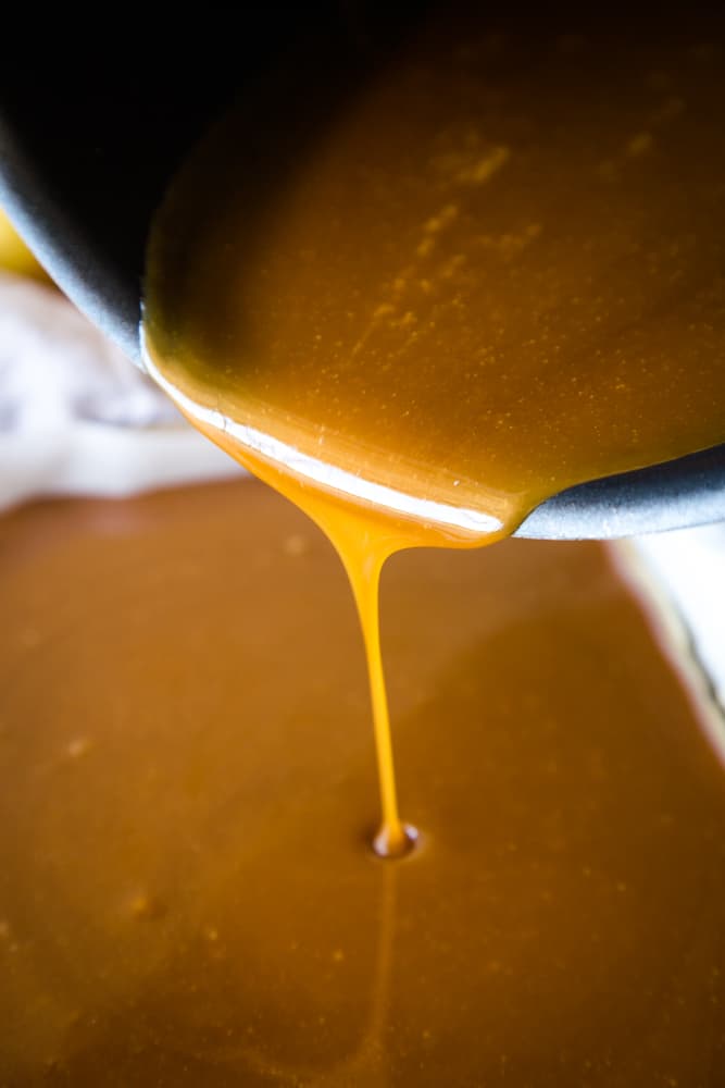 pouring apple caramel recipe out of pan
