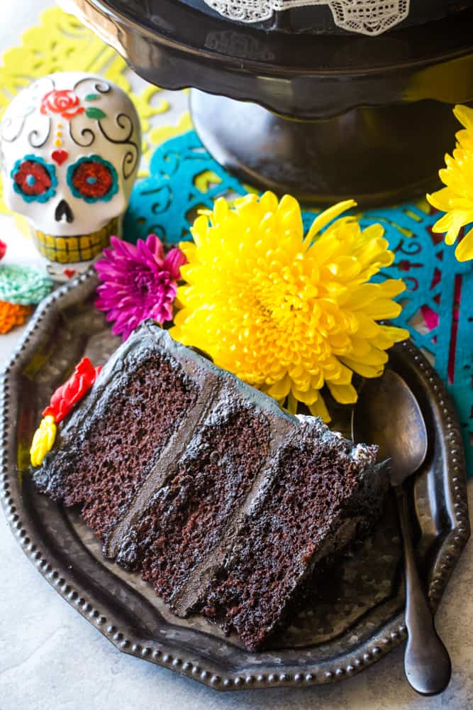 slice of day of the dead cake on black plate