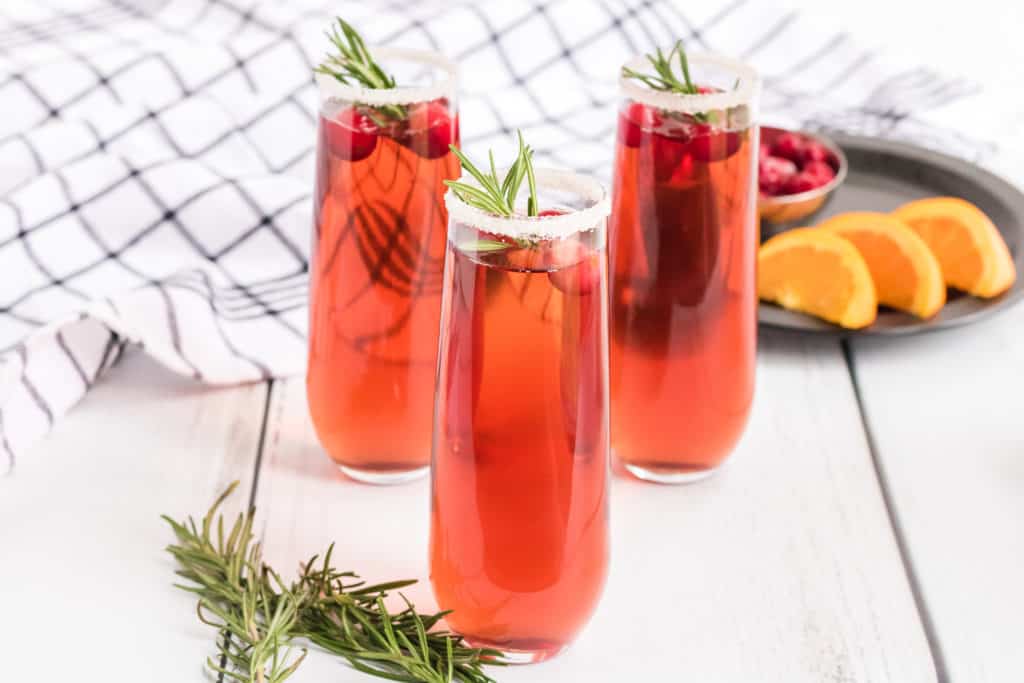 three cups of cranberry champagne