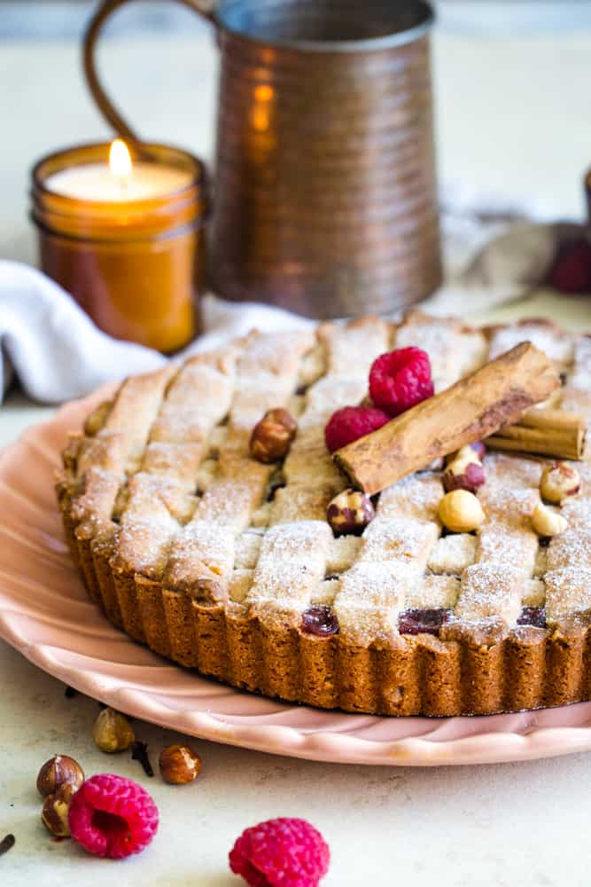 linzer torte on plate with candle in background