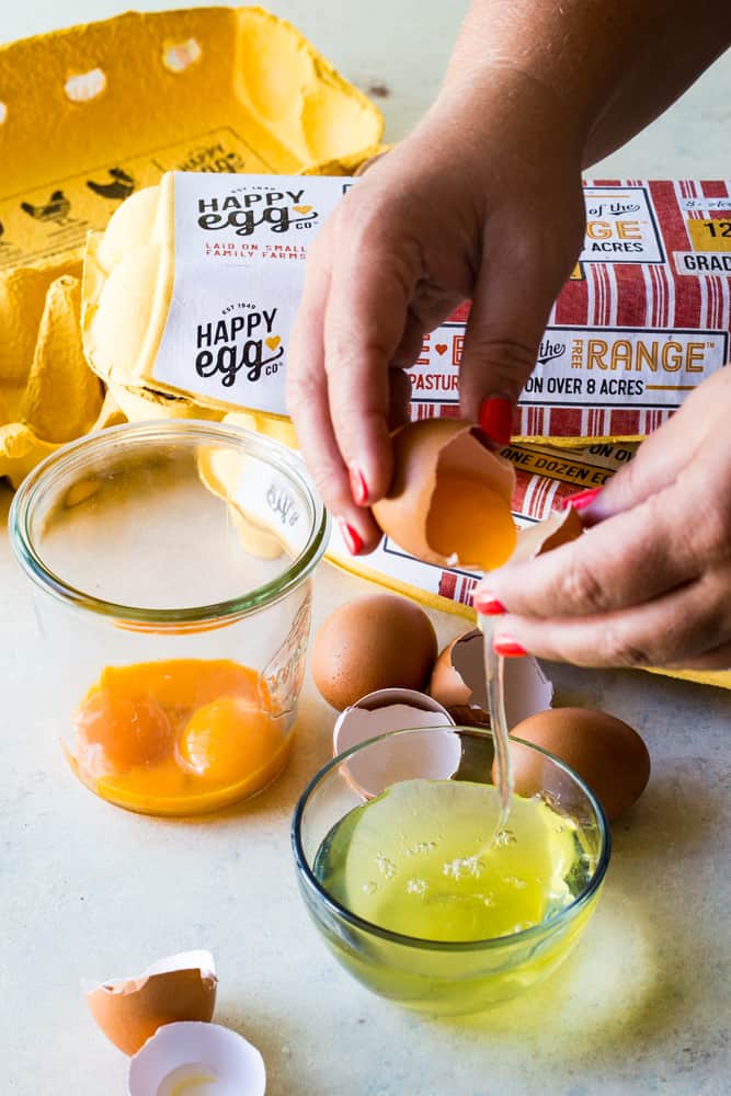 separating the egg whites for pavlova with pomegranate pears