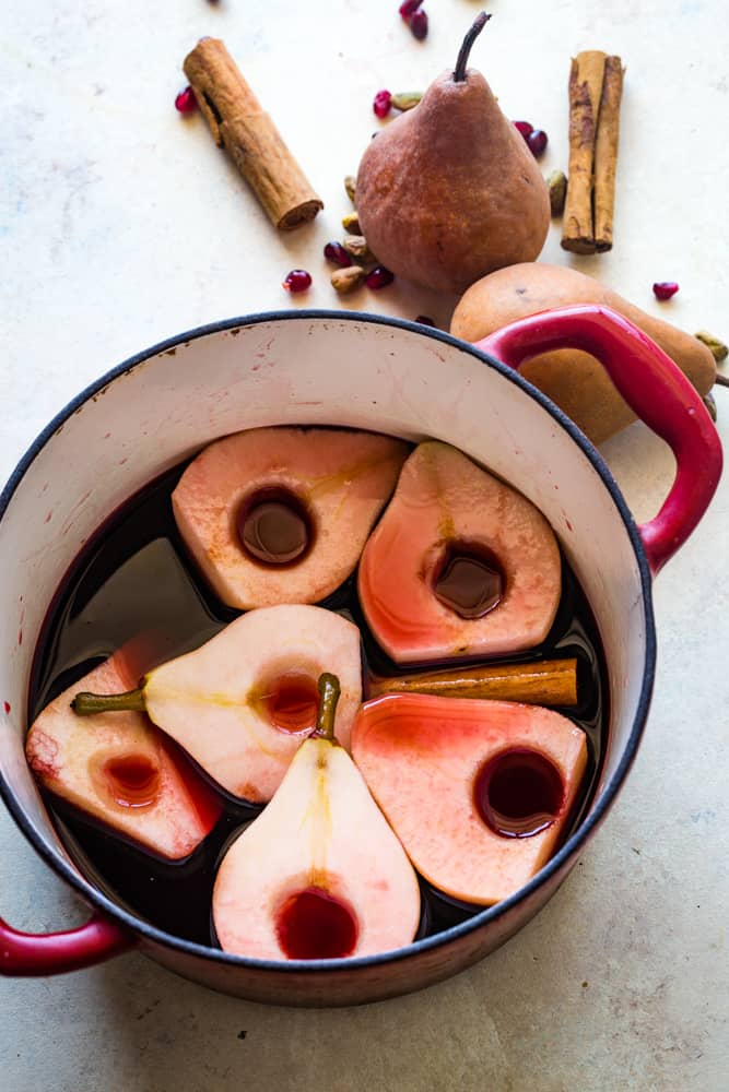 pears in a pot with spices for pavlova with pomegranate pears