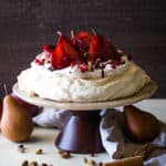 cake stand with pavlova with pomegranate pears