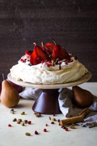 cake stand with pavlova with pomegranate pears