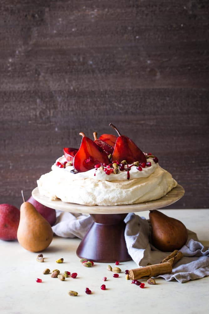 picture of pavlova with pomegranate pears on cake stand