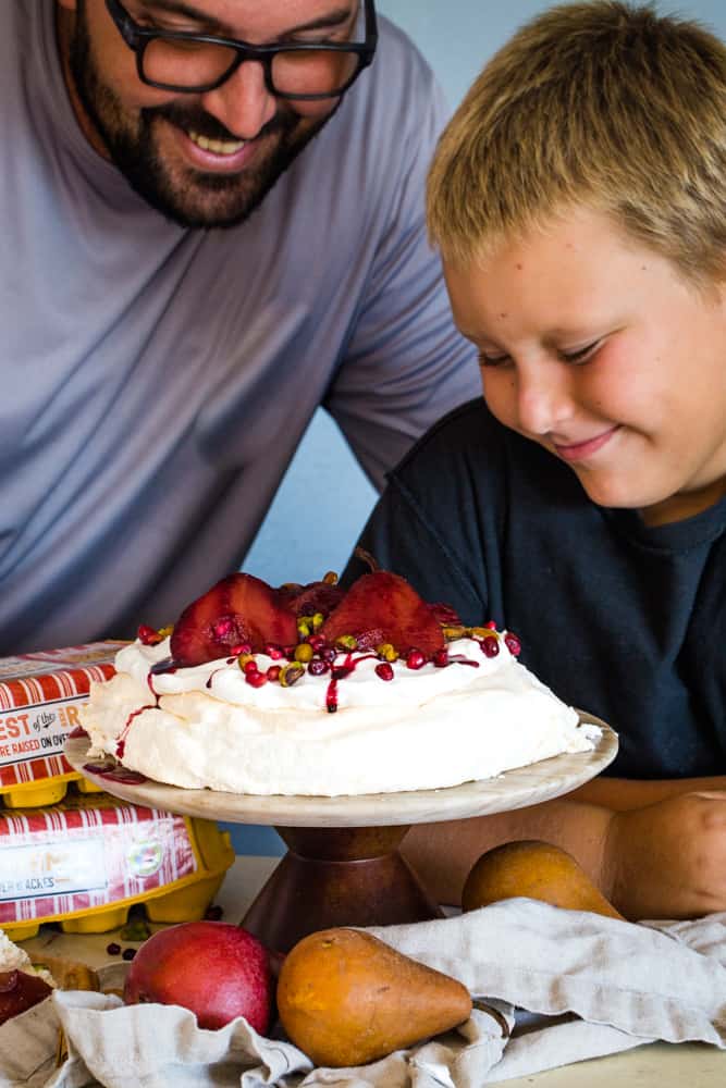 family looking at pavlova with pomegranate pears